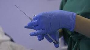 The syringe in the hand of a doctor