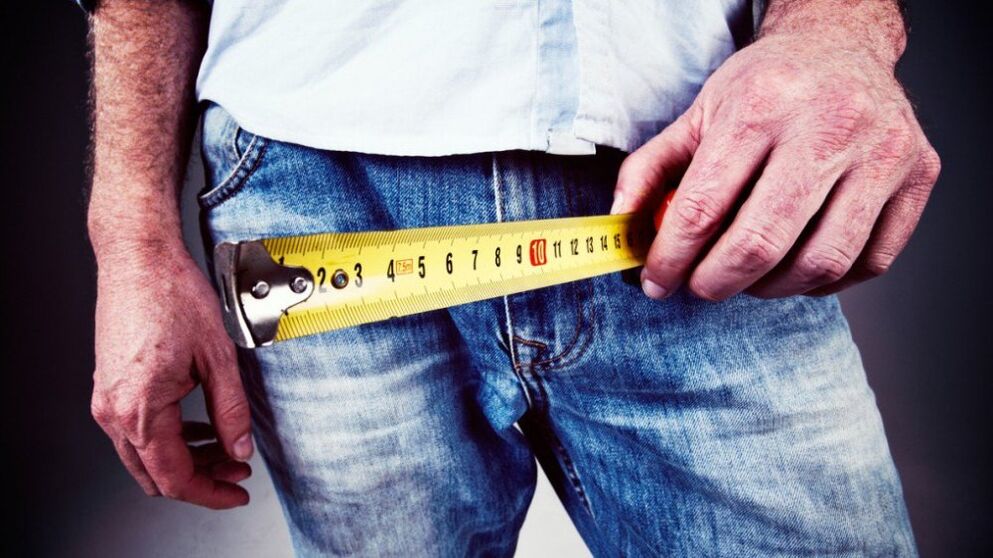 Man measuring his penis after enlarging it with gel